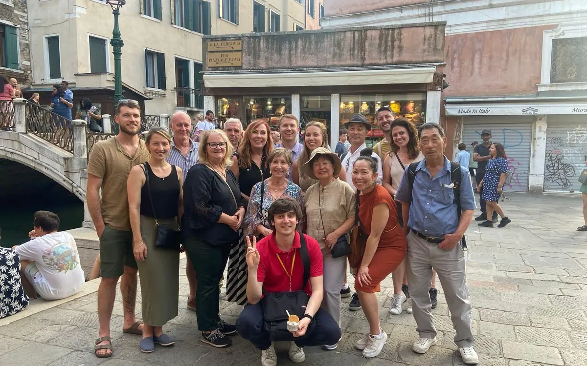 A small group eating cicchetti at a counter in Venice