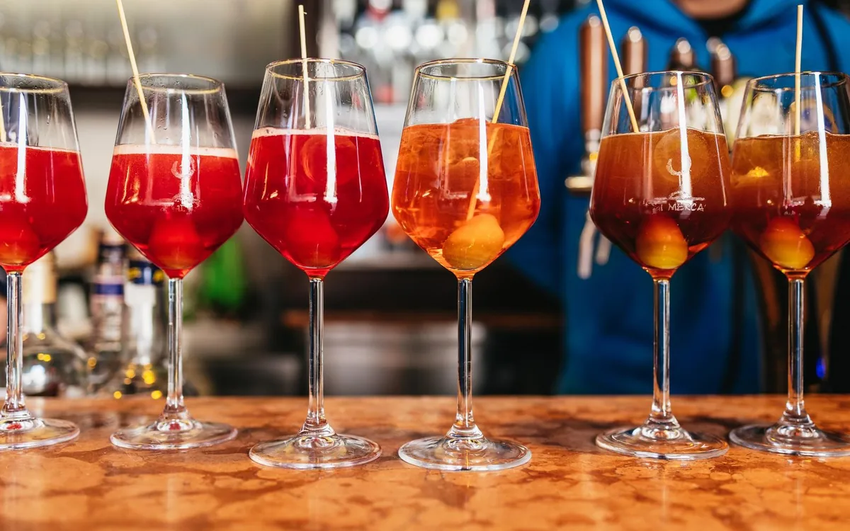 A spritz and small plates on a Venetian counter